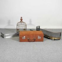 A steel fender, together with a brass fender, a brass birdcage and a suede upholstered case (4)