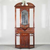 A Victorian style carved hardwood hall stand with a mirrored back 101w x 36d x 218h cm