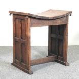 An Arts and Crafts oak stool, with a curved seat and panelled ends 51w x 36d x 55h cm Overall sturdy