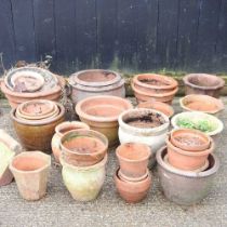 A collection of mainly terracotta garden pots, highest 32cm