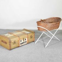 An early 20th century wooden bound trunk, 89cm wide, together with a moses basket on stand (2)