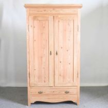 An antique pine double wardrobe, with a single drawer below 113w x 58d x 201h cm