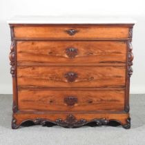 A 19th century French mahogany commode, with a marble top and scrolled decoration 115w x 57d x