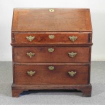 An early 18th century oak bureau, with a hinged sloping fall and fitted interior 91w x 49d x 103h cm