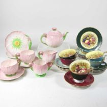 An Aynsley harlequin set of cabinet cups, saucers and plates, printed with fruit, together with a