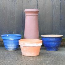 A terracotta chimney pot, 75cm high, together with a terracotta pot and two blue garden pots (4)