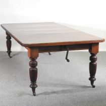 A late Victorian mahogany wind-out extending dining table, on turned legs, with two additional