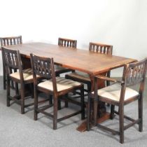A 1960's Ercol dining suite, comprising a refectory table and a set of six matching dining chairs (