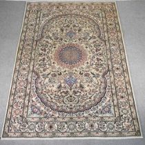 A Persian Nain carpet, with a central medallion and foliate design, on a cream ground, 300 x 200cm