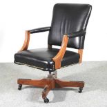 A modern black upholstered revolving desk chair 62w x 94h cm