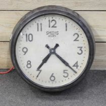 A 1930's Smith's bakelite cased electric wall clock, 34cm wide