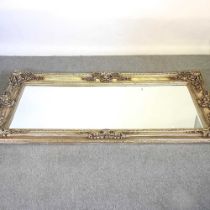 A large silver painted wall mirror, with a swept surround, 204 x 97cm