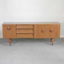 A 1970's laminated sideboard, on tapered legs 182w x 45d x 72h cm