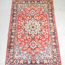 A Persian rug, with a central medallion and all over foliate designs, 250 x 160cm