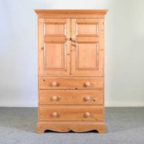 A pine cabinet, enclosed by panelled doors, with drawers below 95w x 49d x 160h cm