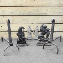 A cast iron Mr Punch doorstop, 33cm high, together with three others and a pair of iron fire dogs