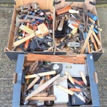 A collection of various hand tools and garden trugs