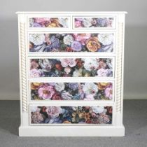 A white painted and floral decorated chest of drawers 130w x 40d x 115h cm