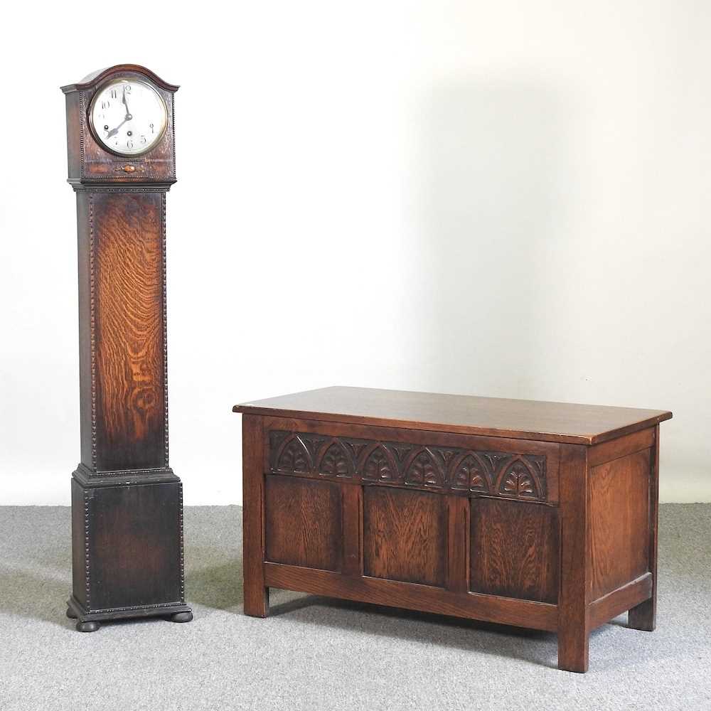A 1920's oak blanket box, together with a 1930's oak cased granddaughter clock (2) 91w x 44d x 51h