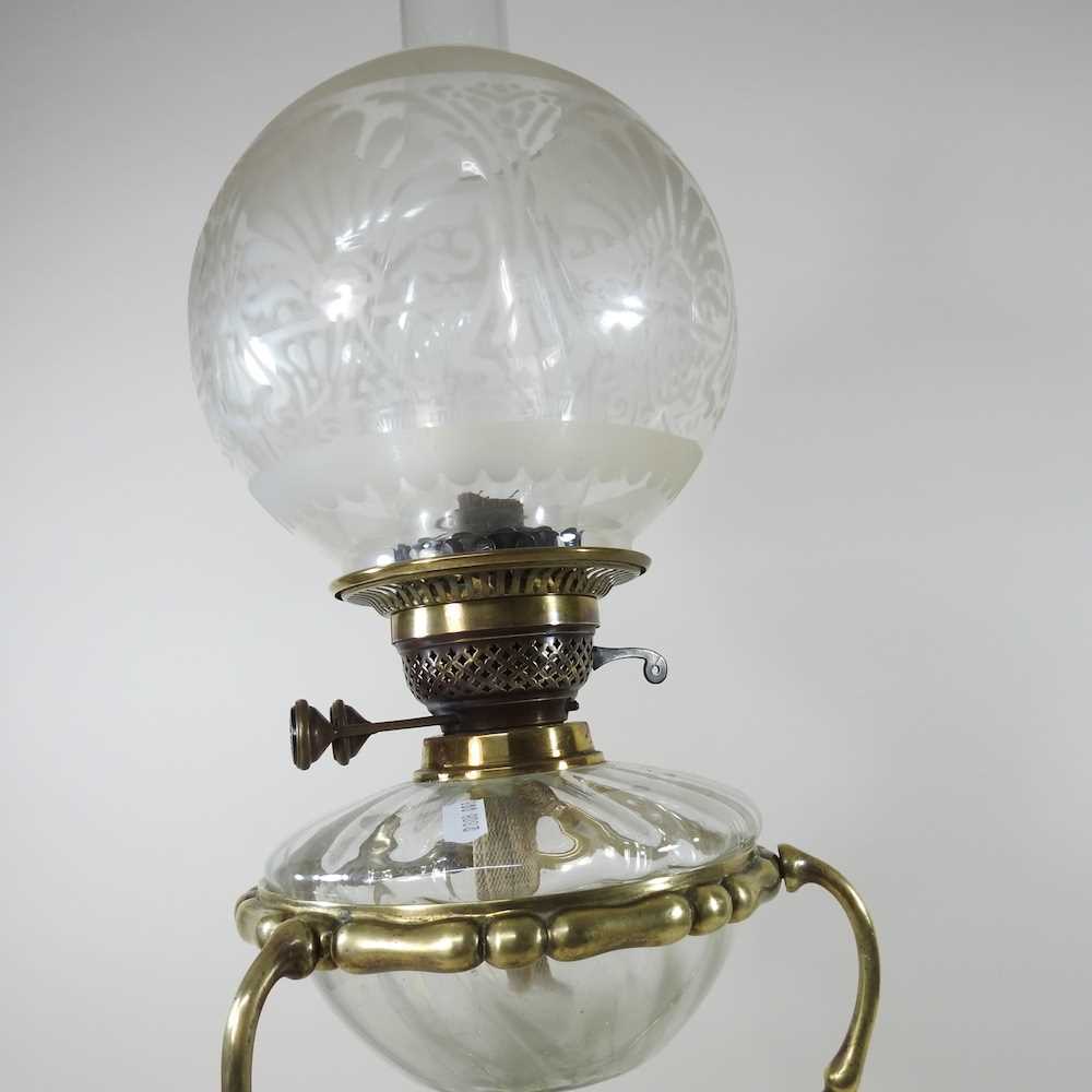 An ornate 19th century brass oil lamp, with an etched glass shade, clear glass font and scrolled - Image 6 of 6