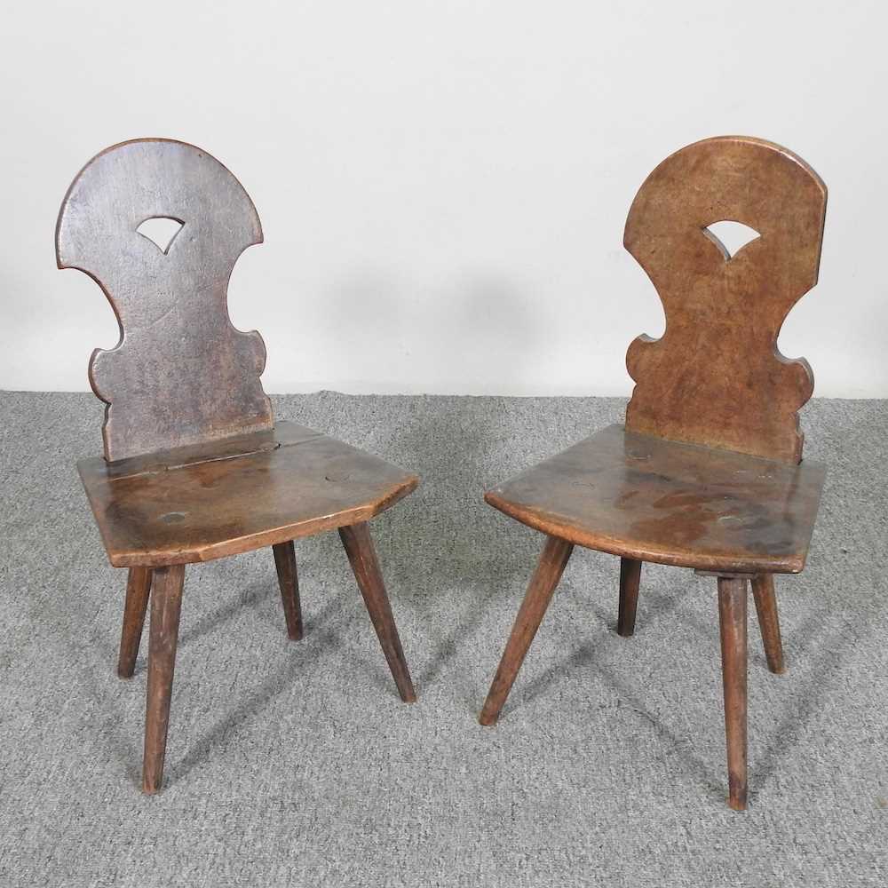 A pair of 19th century carved mahogany child's hall chairs, each with a shield shaped back and solid
