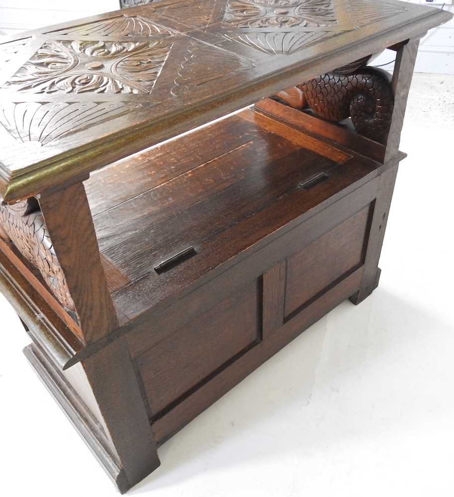 An early 20th century carved oak monk's bench, with griffin supports 92w x 50d x 82h cm - Image 10 of 10