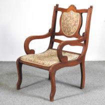 An Edwardian walnut and inlaid open armchair