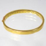 An Edwardian 14 carat gold bangle, of hinged design, inscribed and dated Nov. 6th 1906, 11g, 6cm