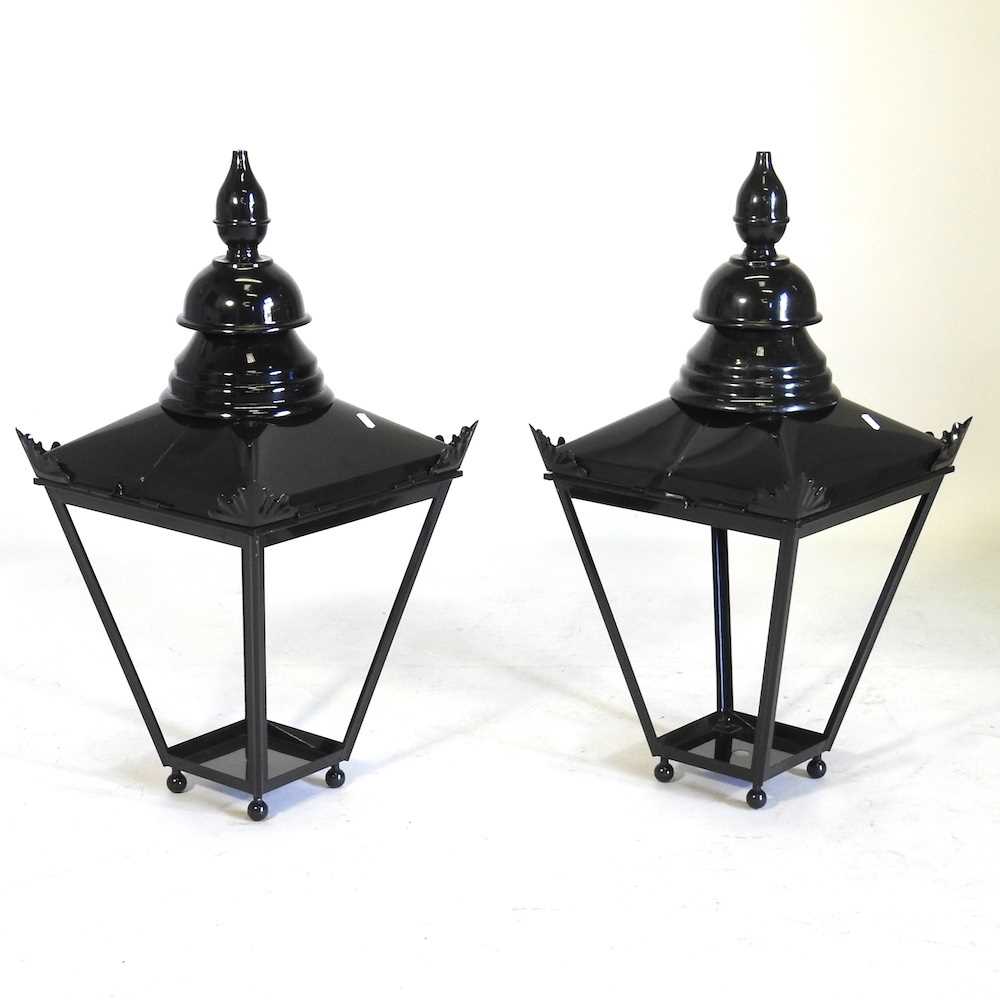 A pair of black painted metal garden lanterns, each 77cm high (2)