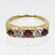 An 18 carat gold ruby and diamond ring, set with five alternating stones, 2.9g, size M, boxed