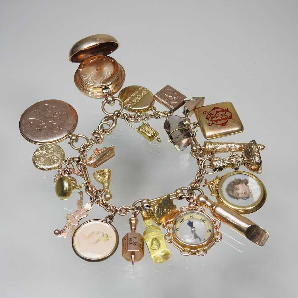 A gold charm bracelet, suspended with twenty-three various novelty charms, to include a sovereign - Image 4 of 12