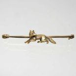 A 15 carat gold brooch, decorated with a fox, with gem set eyes, 5.4g, 55mm wide