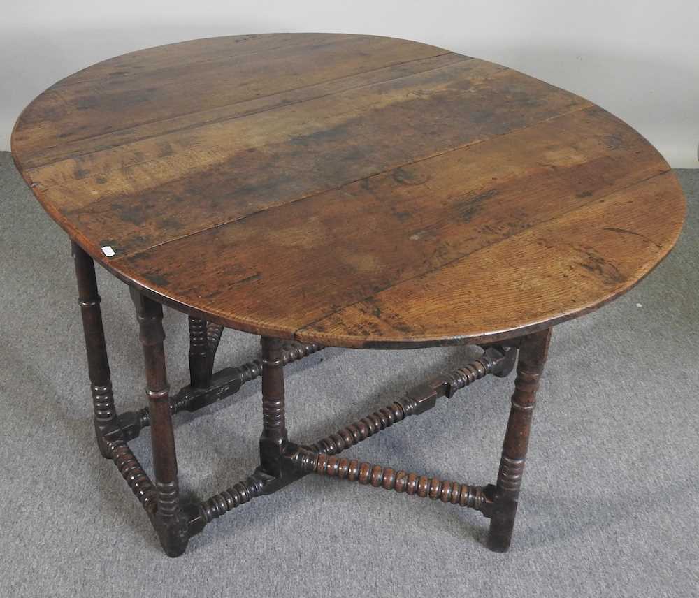 An 18th century oak gateleg table, with a hinged oval top, on bobbin turned legs 108w x 44d x 72h cm - Image 5 of 5