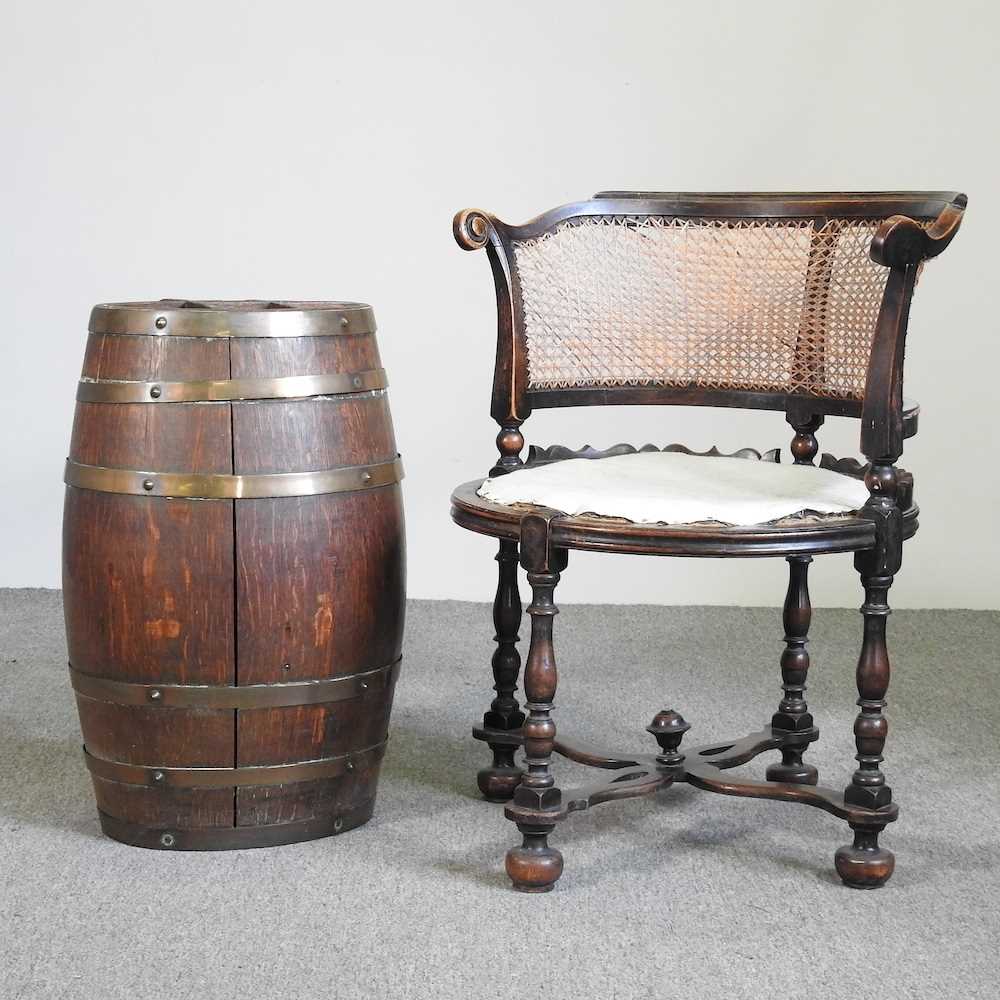 A stickstand, in the form of a coopered oak barrel, together with a cane seated armchair (2)