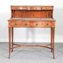 A reproduction yew wood writing desk, on splayed legs 95w x 49d x 103h cm