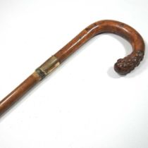 An early 20th century carved wooden walking stick, with an 18 carat gold collar, 84cm long