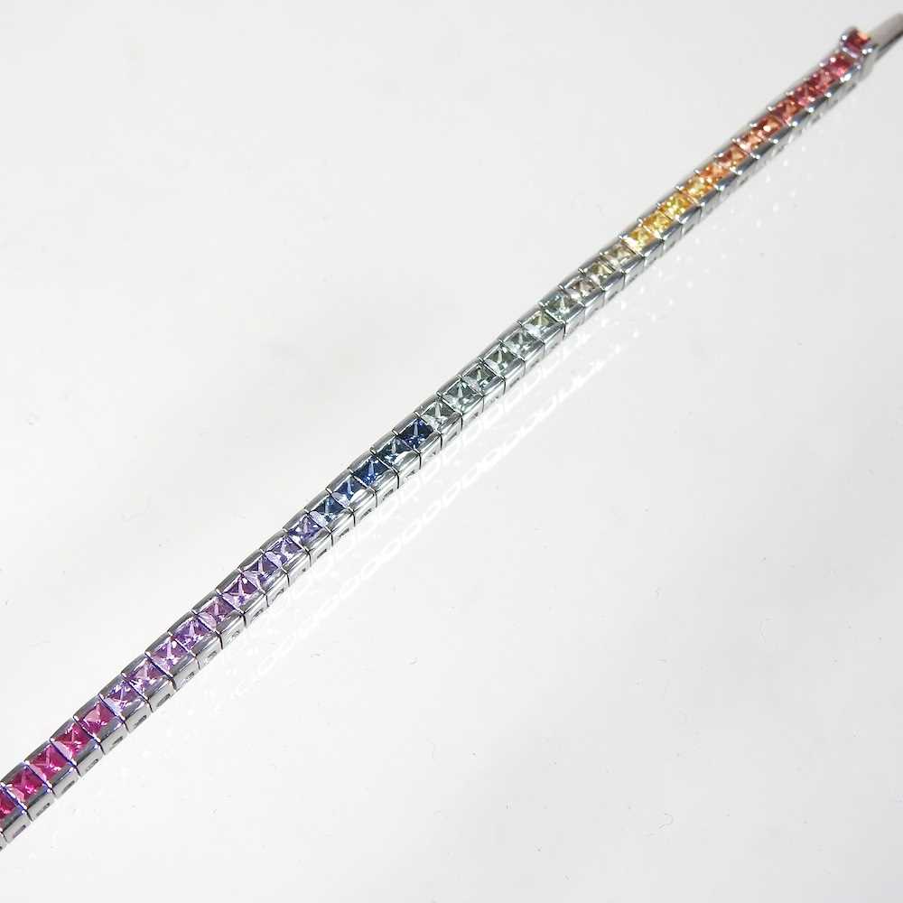 A 9 carat white gold, fancy sapphire and diamond line bracelet, set with a single row of