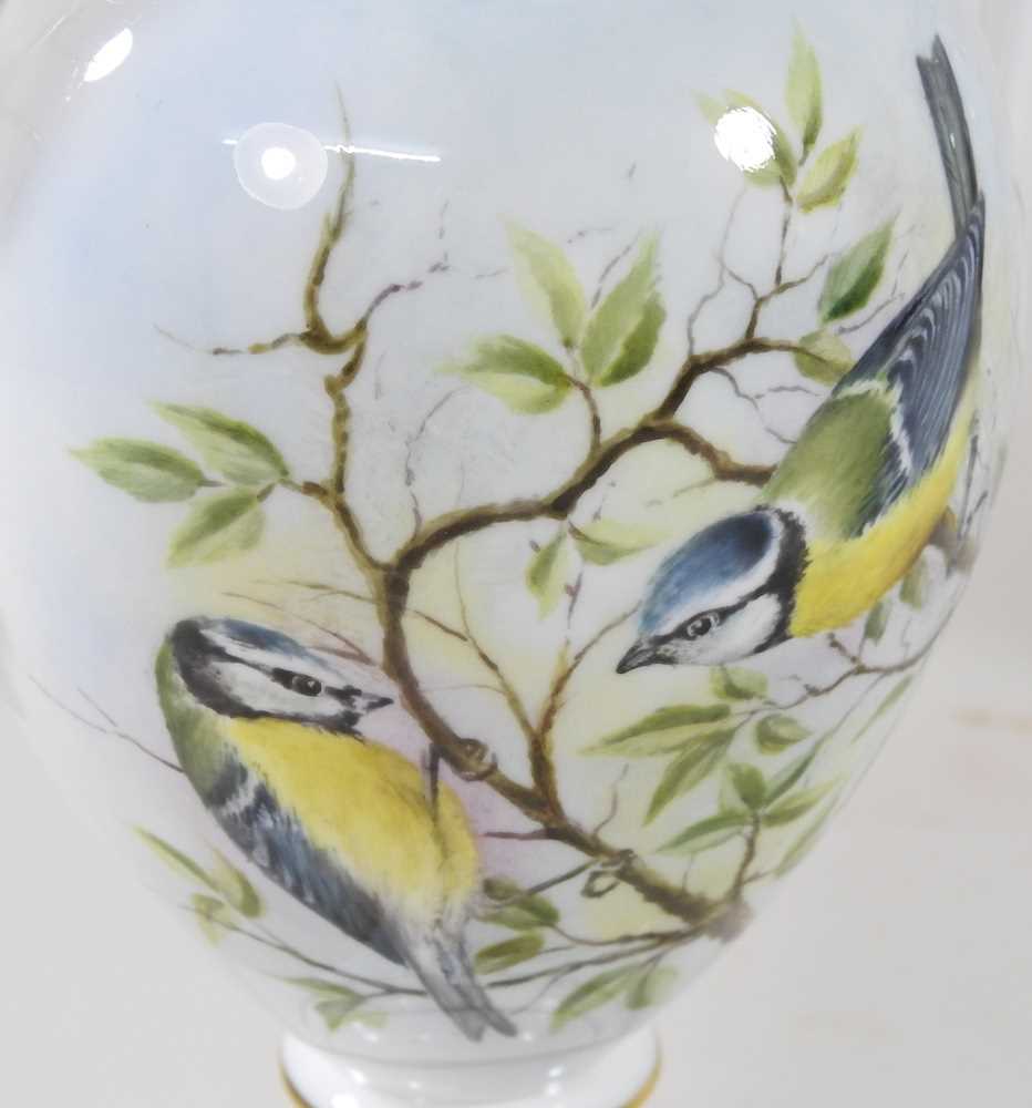 A pair of Royal Worcester porcelain vases, each of twin handled baluster shape, painted with a - Image 2 of 10