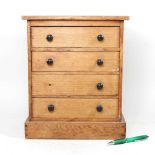 A Victorian pine miniature chest, containing four long drawers, on a plinth base 29w x 22d x 35h cm