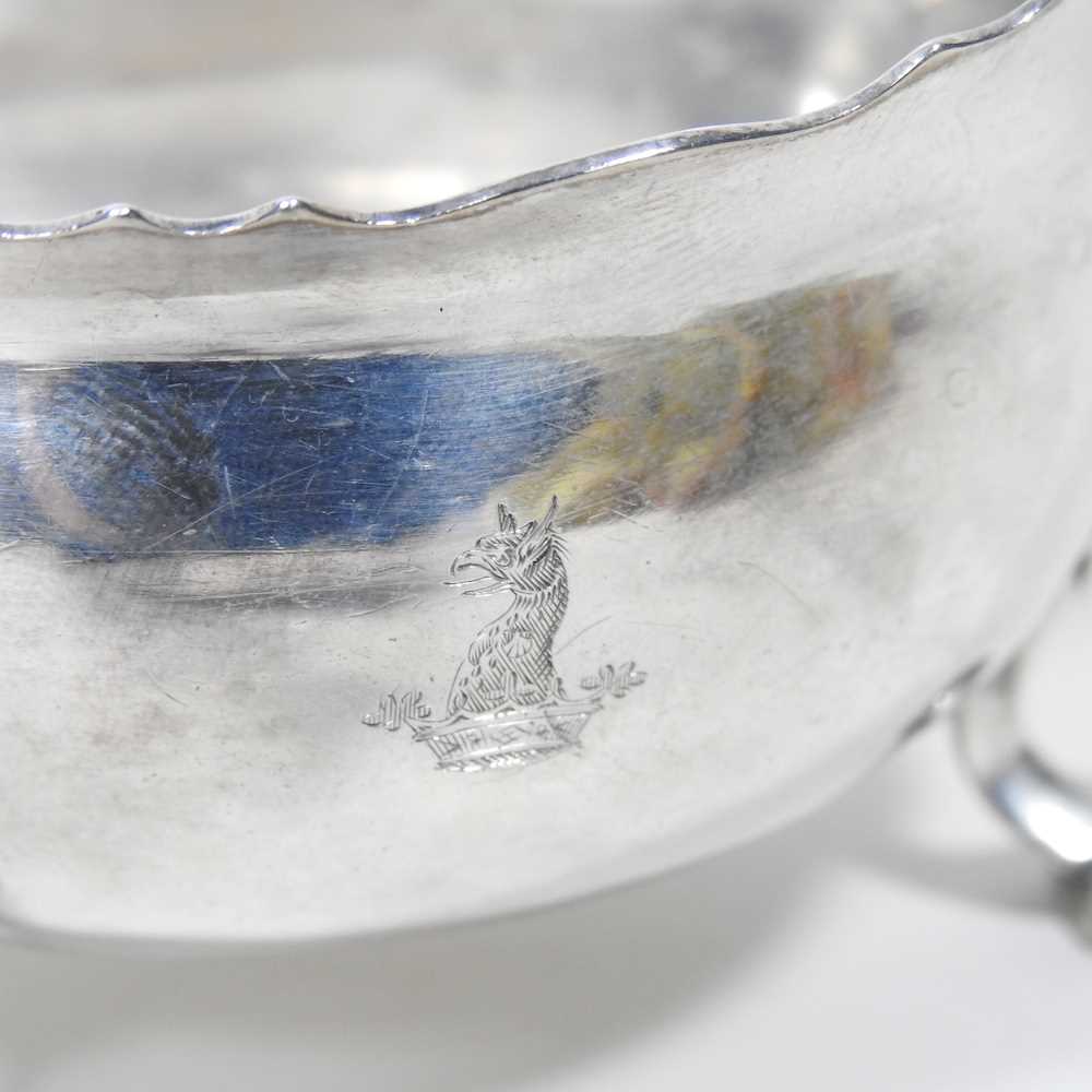 A George II silver sauce boat, of helmet shape, with a flying scrolled handle, on hoof feet, - Image 3 of 5