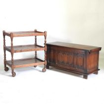 A 1920's oak coffer, with a hinged lid, 96cm wide, together with a 1920's tea trolley (2) 96w x