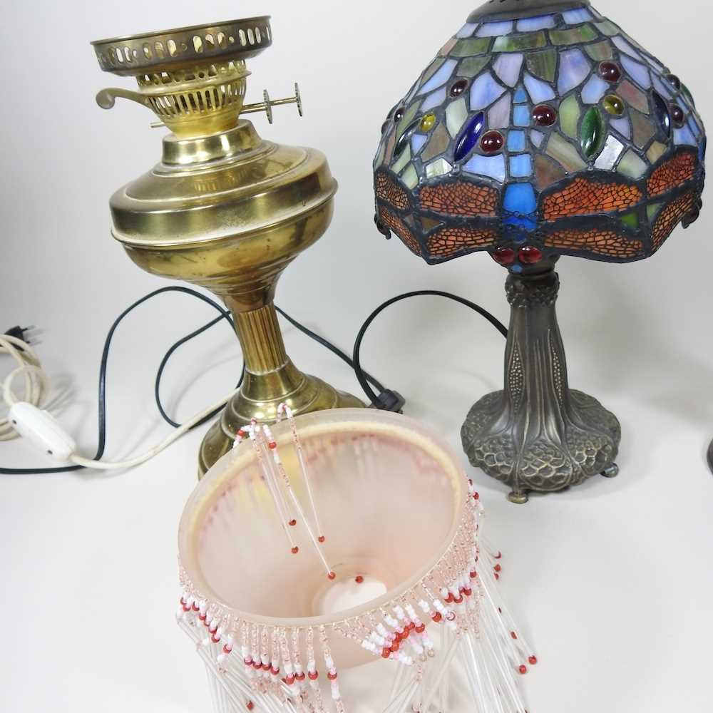 A converted brass oil lamp, together with a Tiffany style table lamp and a figural table lamp (3) - Image 2 of 5