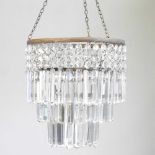 A glass chandelier, with prism shaped drops, 32cm diameter