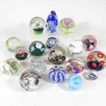 A collection of eighteen various coloured glass paperweights, to include Caithness (18)