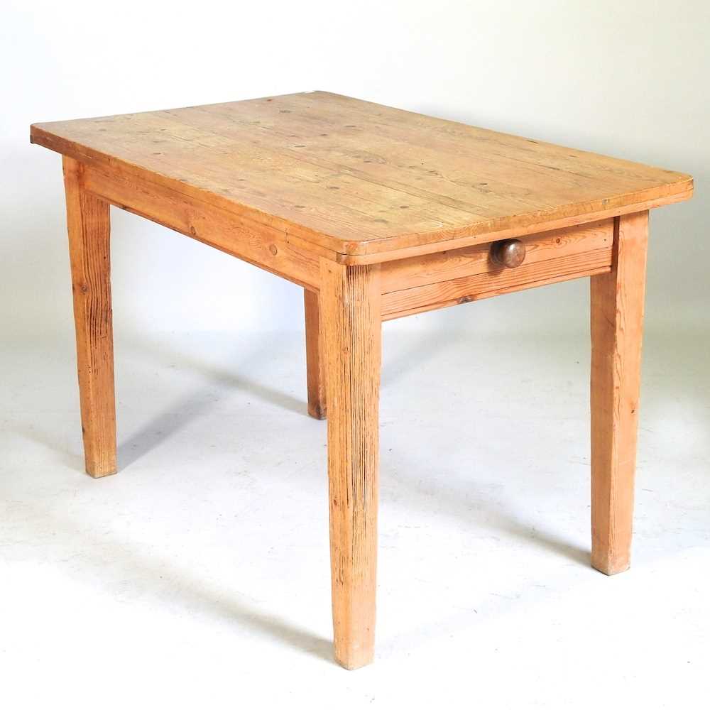 An antique pine dining table, containing a single drawer, together with a modern light oak framed