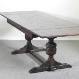A mid 20th century oak draw leaf dining table, on cup and cover legs 275w x 92d x 76h cm