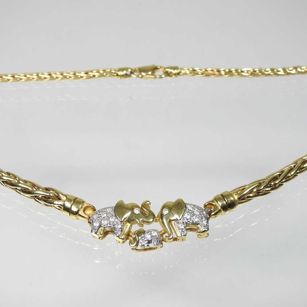A fancy link necklace, suspended with three elephants, each set with zircons, marked 750, 20g,