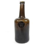 An 18th century English brown glass sealed wine bottle, inscribed All Souls Coll:C:R, 26cm high