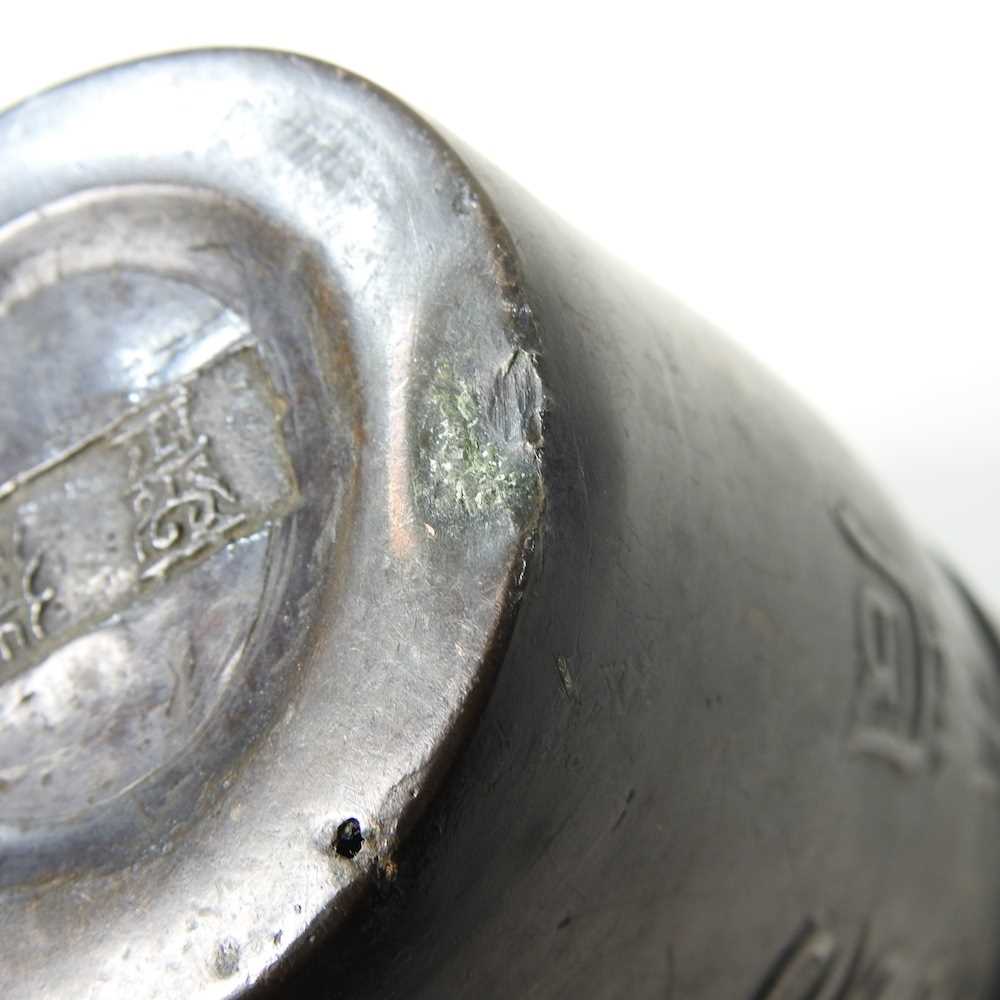 A Chinese bronze beaker, decorated in relief with symbols, signed to base, 13cm high - Image 7 of 7