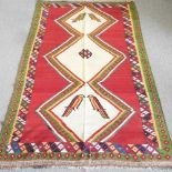 A kilim rug, with a cream central panel, decorated with birds, 290 x 145cm